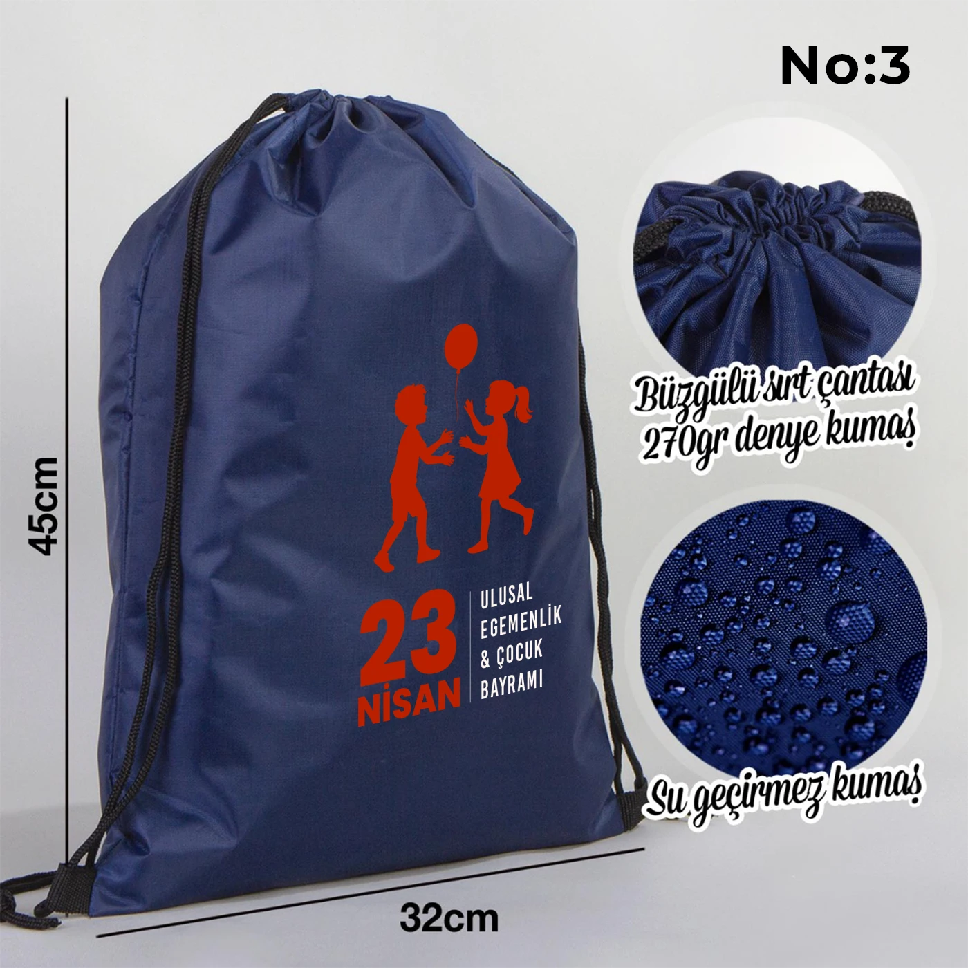 32x45 cm lacivert büzgülü sırt çantası üzerinde “Yaşasın 23 Nisan” yazılı çocuk temalı renkli baskı, roket ve kâğıt uçak detayları, kutlama temalı sınıf arka planı