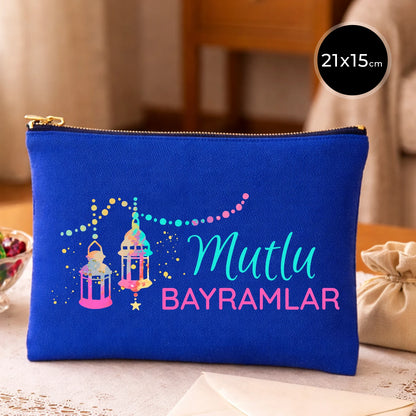 Saks mavisi kanvas 21x15 cm elde taşınabilir clutch, siyah fermuarlı, fener motifli “Mutlu Bayramlar” yazılı çanta