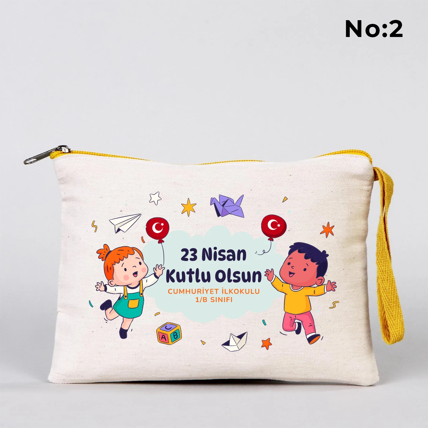 23 Nisan temalı 21x15 cm fermuarlı bez kalemlik üzerinde dünya etrafında el ele çocuk figürleri, “23 Nisan Ulusal Egemenlik ve Çocuk Bayramı Kutlu Olsun” yazısı ve okul - sınıf özelleştirilebilir alan.