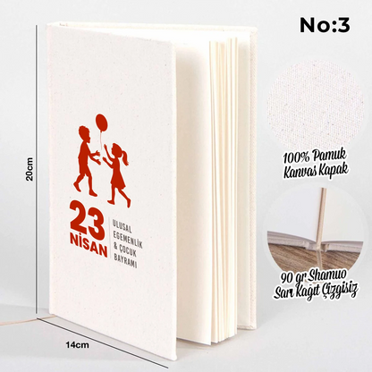 14x20 cm bez kaplı defter üzerinde renkli “23 Nisan Kutlu Olsun” yazı tasarımı bulunan çocuk temalı hediye defter.