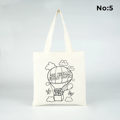 23x23 cm krem renkli bez çanta üzerinde boyamaya uygun “23 Nisan Kutlu Olsun” yazılı siyah beyaz baskı ve sınıf temalı arka plan