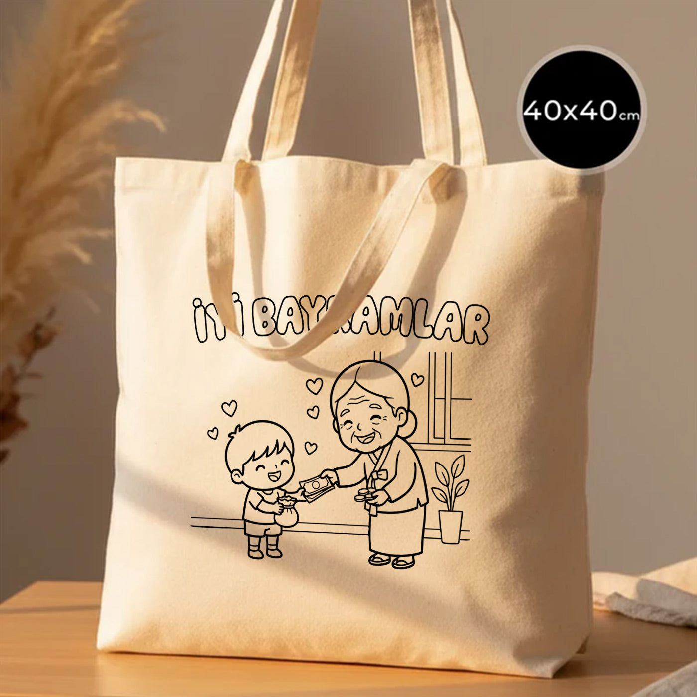 40x40 cm boyanabilir ham bez tote çanta; doğal pamuk kanvas kumaş, uzun kulplu, ön yüzünde “İyi Bayramlar” yazısı ve büyükanne–torun bayramlaşma çizimi bulunan geniş günlük bayram çantası / bayram harçlığı çantası.