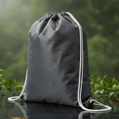 Su geçirmez antrasit büzgülü sırt çantası, 32x45 cm ölçülerinde, baskısız, günlük ve dış mekan kullanımı için ideal.