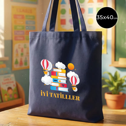 Navy blue 35x40 cm gabardine cotton tote bag with 70 cm handles, non-gusseted, standing upright on a desk in a warm, colorful classroom setting.